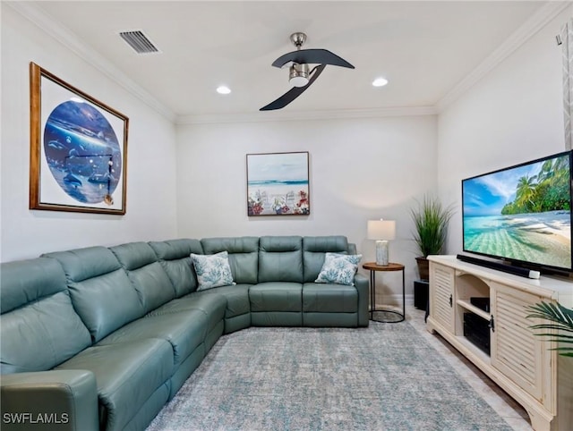 living room with ceiling fan and ornamental molding