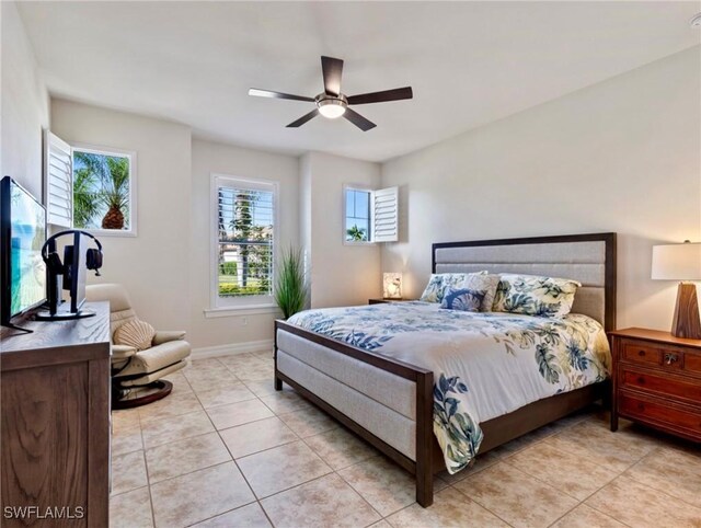 tiled bedroom featuring ceiling fan