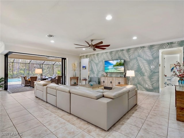 living room with ceiling fan, light tile patterned floors, and ornamental molding