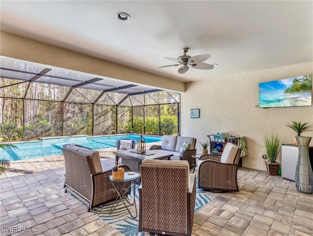 view of patio / terrace featuring a lanai, ceiling fan, and an outdoor hangout area