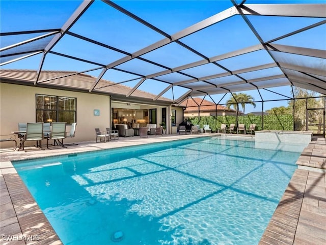 view of swimming pool featuring a lanai, a patio area, and outdoor lounge area