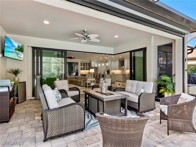 view of patio / terrace with ceiling fan and an outdoor hangout area