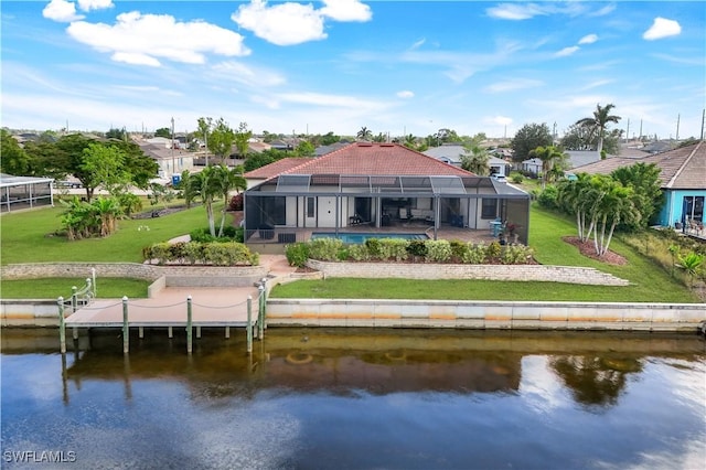 back of house featuring a yard, a water view, glass enclosure, and a swimming pool