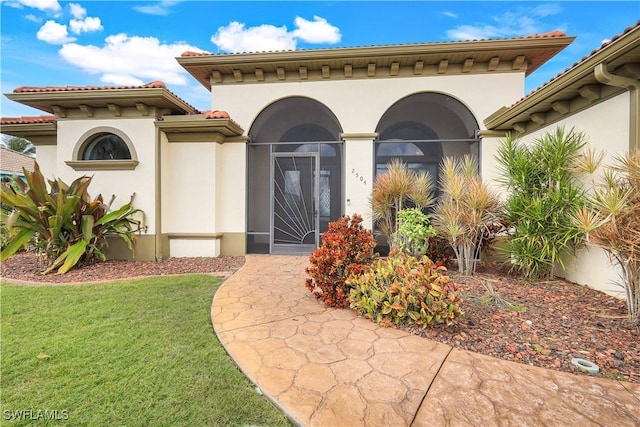 doorway to property featuring a yard