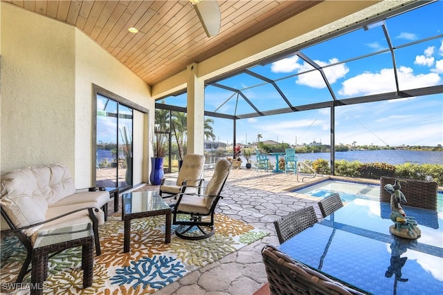 view of patio / terrace featuring a water view and a lanai