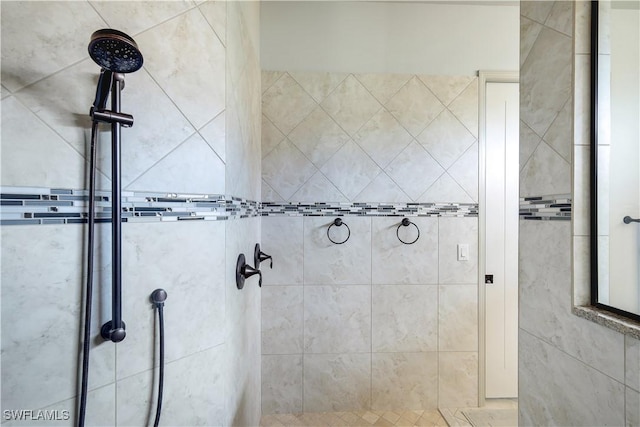 bathroom with tiled shower