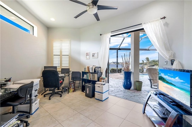 office area featuring ceiling fan, light tile patterned floors, and a healthy amount of sunlight