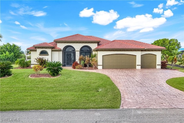 mediterranean / spanish-style home with a front yard and a garage