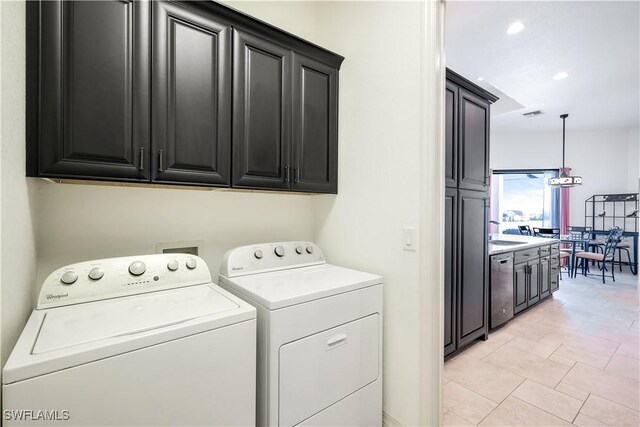 laundry room featuring cabinets, independent washer and dryer, light tile patterned floors, and sink