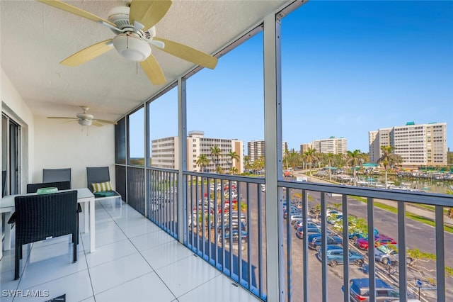 balcony with a city view and ceiling fan