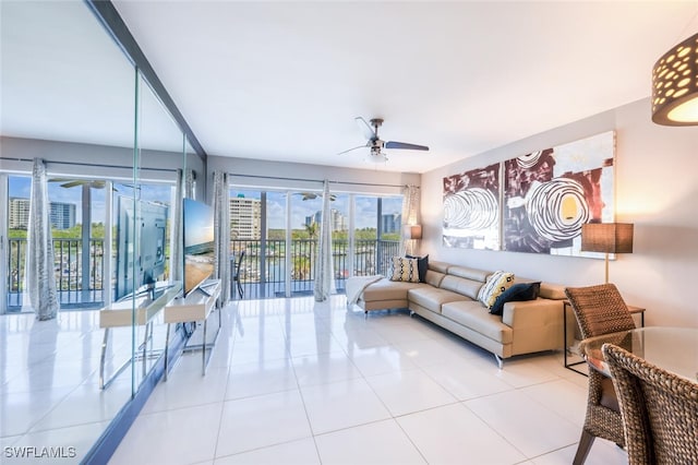 living room featuring a ceiling fan and tile patterned floors