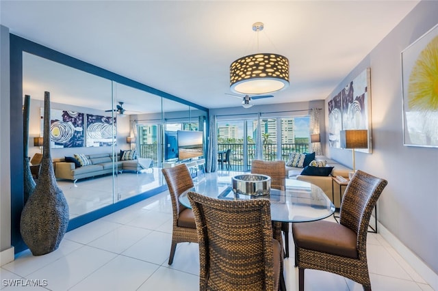 1 Bluebill Ave Unit 503, Naples, FL 34108 - dining space with baseboards, a ceiling fan, and tile patterned floors