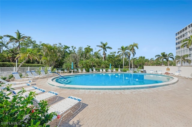 pool featuring fence and a patio