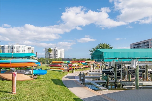 exterior space featuring a view of city, a yard, a dock, and boat lift