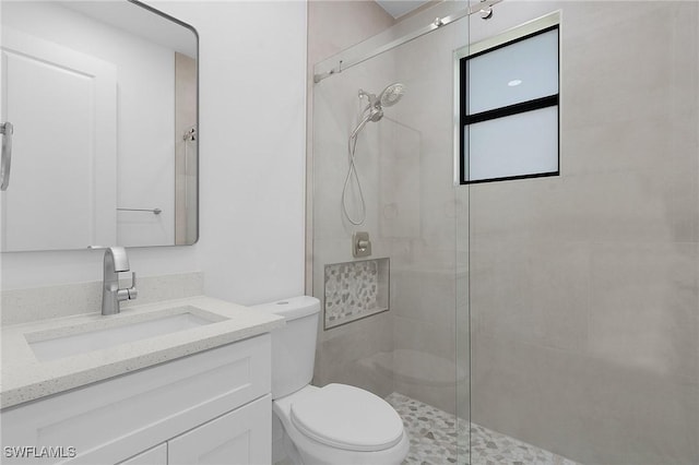 full bath featuring a shower stall, toilet, and vanity