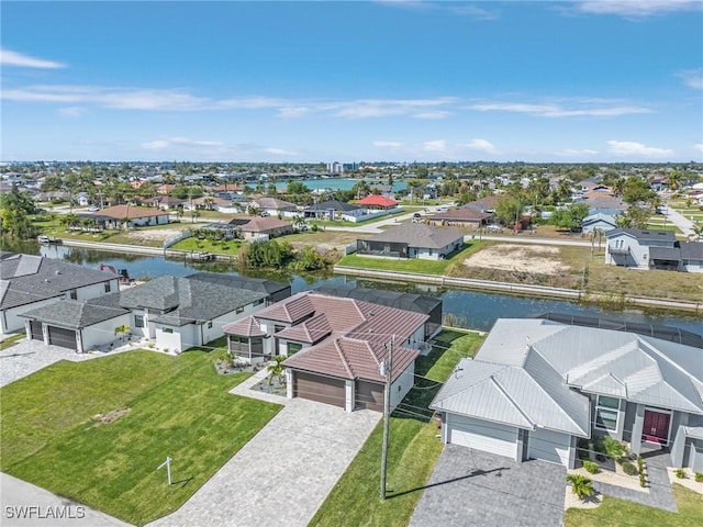 drone / aerial view featuring a residential view and a water view