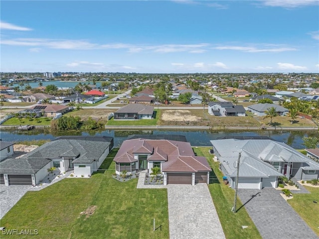 drone / aerial view featuring a residential view and a water view