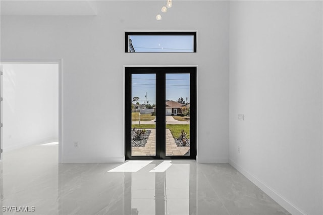 foyer featuring baseboards and marble finish floor