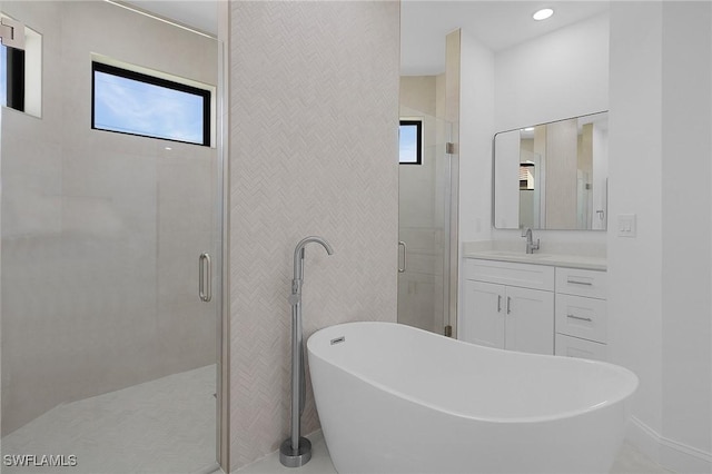 bathroom featuring vanity, a shower stall, and a freestanding bath