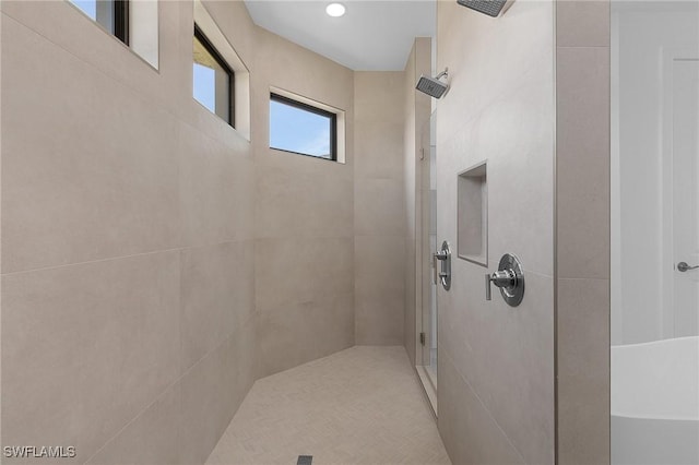 full bath with a tile shower