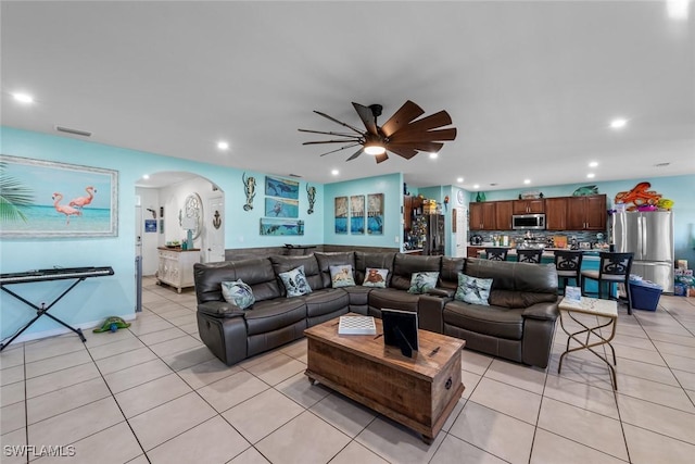 tiled living room featuring ceiling fan