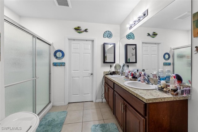 bathroom featuring vanity, tile patterned floors, and walk in shower