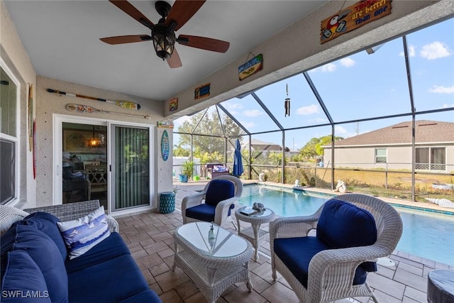 view of patio / terrace with outdoor lounge area, ceiling fan, a lanai, and a fenced in pool