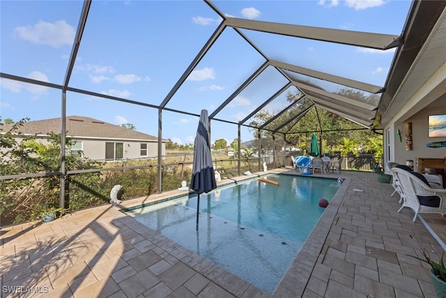 view of swimming pool with a patio and glass enclosure