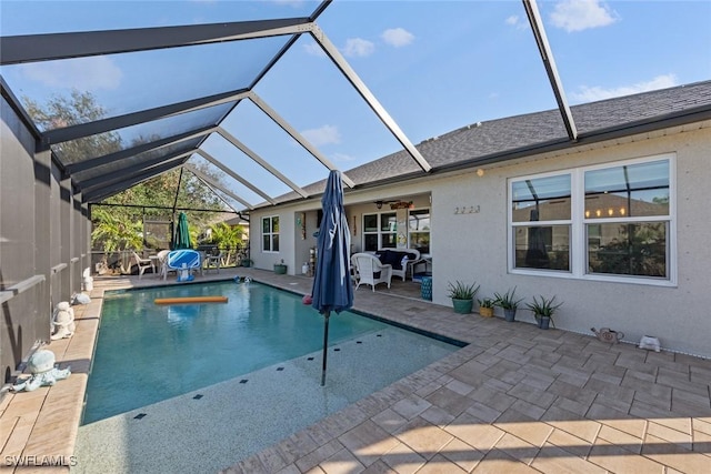 view of pool featuring ceiling fan, a lanai, and a patio area