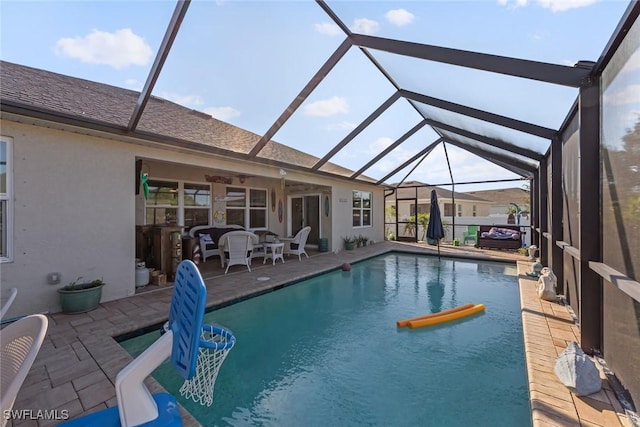 view of pool with a patio and glass enclosure