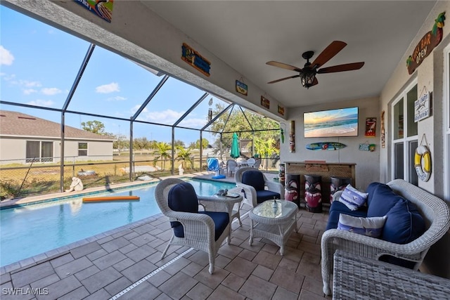 view of patio / terrace with outdoor lounge area, ceiling fan, and glass enclosure