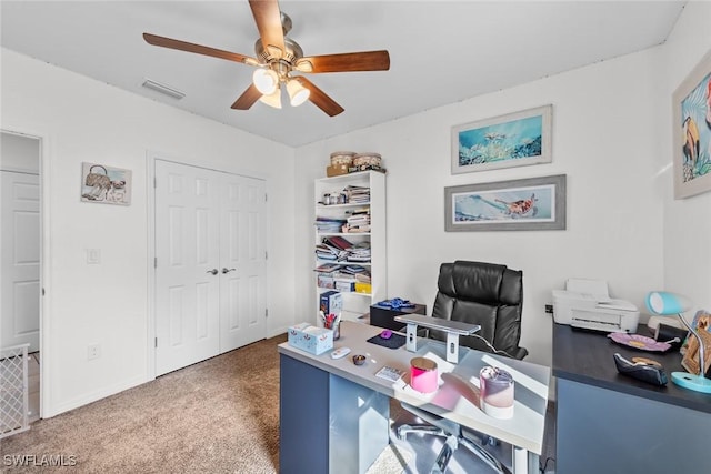 carpeted home office with ceiling fan