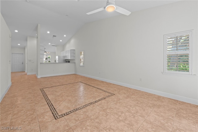 interior space with ceiling fan, light tile patterned floors, and high vaulted ceiling