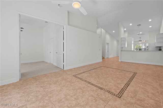 unfurnished living room featuring ceiling fan, light tile patterned floors, and high vaulted ceiling