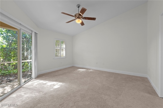 carpeted empty room featuring ceiling fan and vaulted ceiling