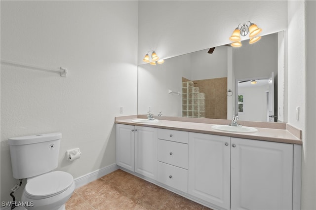 bathroom featuring a shower, tile patterned floors, vanity, and toilet