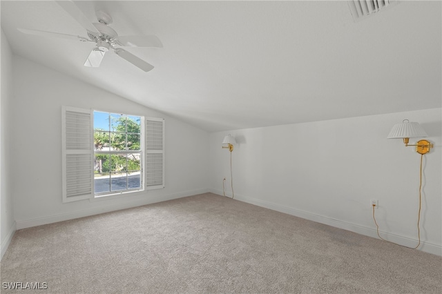 carpeted empty room featuring ceiling fan and lofted ceiling