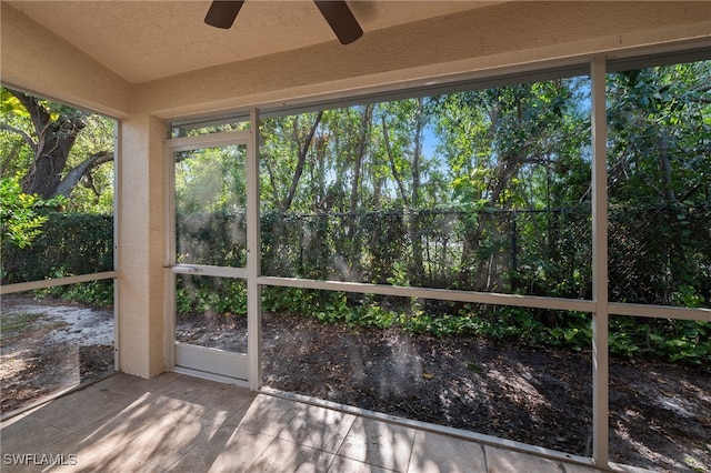 unfurnished sunroom featuring vaulted ceiling