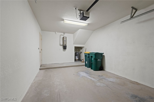 garage with electric water heater and a garage door opener