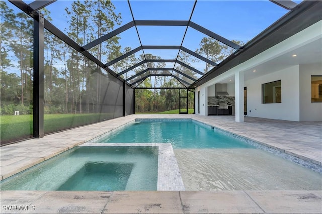 view of swimming pool featuring a lanai and a patio area