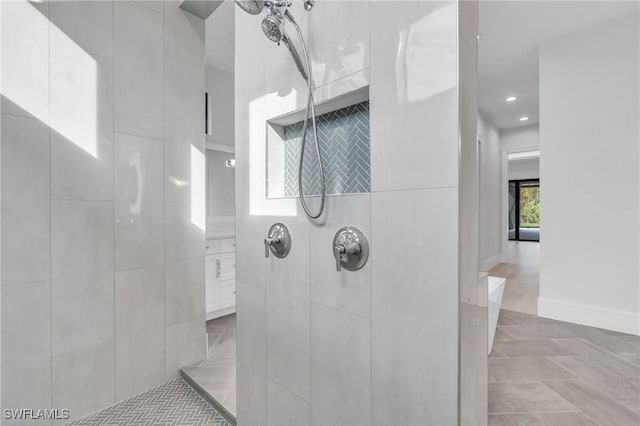 bathroom featuring tile patterned floors and tiled shower