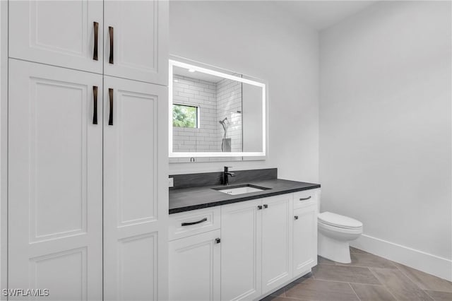 bathroom with tile patterned flooring, vanity, and toilet