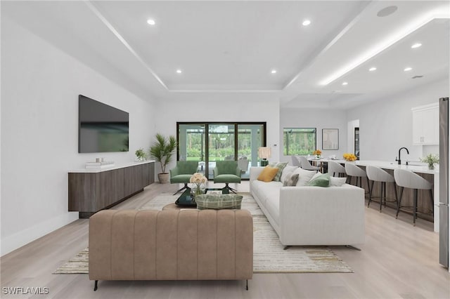 living room with light hardwood / wood-style flooring and sink