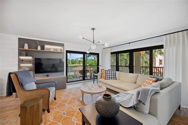 living room featuring plenty of natural light and an inviting chandelier