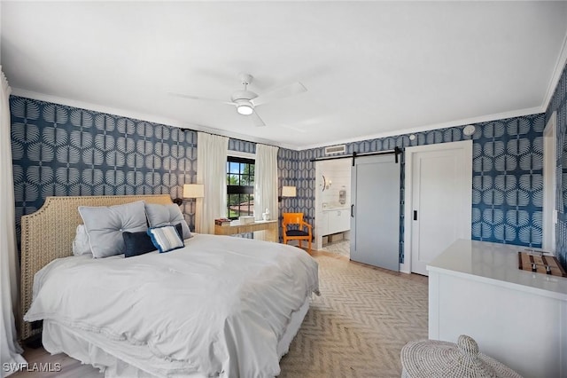 bedroom with a barn door, ceiling fan, and ornamental molding