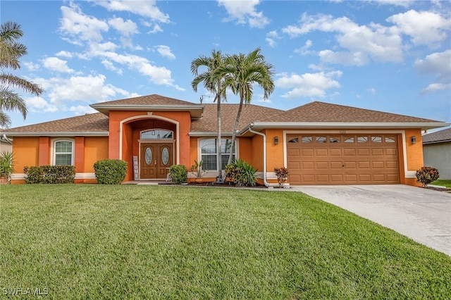 view of front of home with a garage and a front lawn