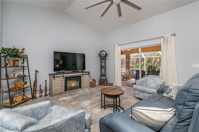 living room featuring ceiling fan and lofted ceiling