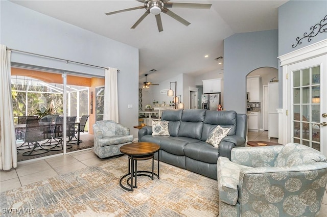 tiled living room with ceiling fan and lofted ceiling