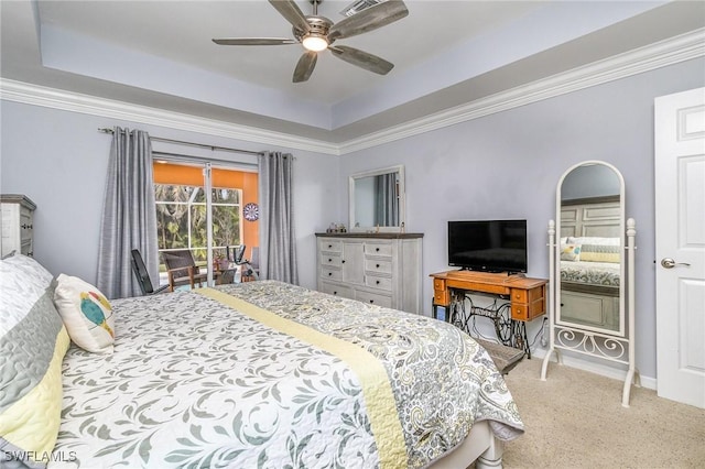 bedroom featuring carpet, a tray ceiling, and ceiling fan