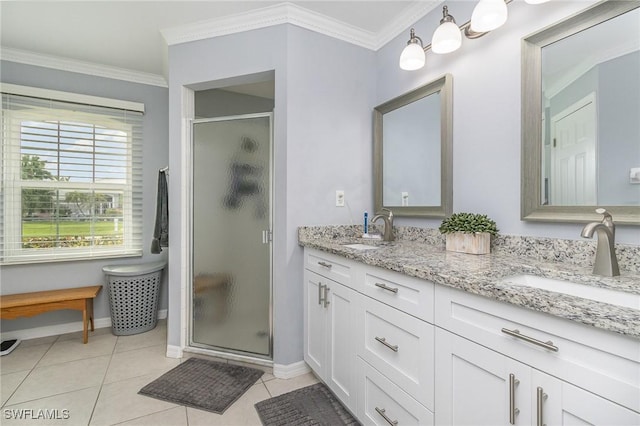 bathroom with tile patterned floors, vanity, a shower with shower door, and ornamental molding